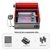 The image shows a red-framed Creality Falcon2 Pro 22W Enclosed Laser Engraver and Cutter with a pink floral design platform, boasting FDA Class 1 Safety Certification. Below are expansion kits: honeycomb workbench, rotary roller, and four raisers for enhanced engraving versatility.