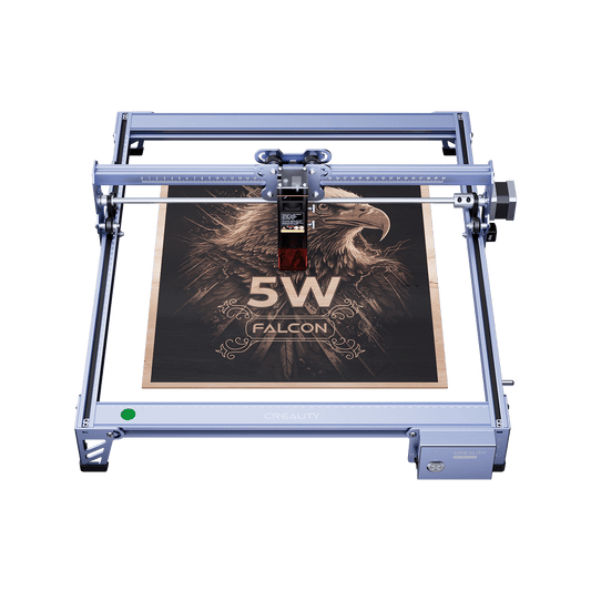 The Creality Falcon CR 5W Diode Laser Engraver etches an eagle image with "5W FALCON" onto wood. Its metallic frame ensures ultra-fine engraving precision, delivering impressive detail. 1600