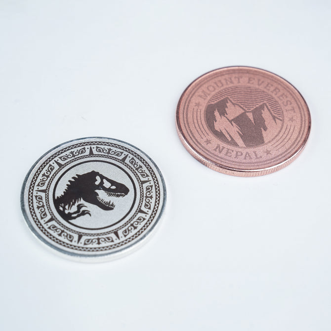 Two Creality Falcon 3-Color Blank Commemorative Coins for Laser Engraver (6pcs) are shown on a white surface: one silver with a dinosaur skull design, and one copper featuring mountains and "Mount Everest Nepal" text. Two Creality Falcon 3-Color Blank Commemorative Coins for Laser Engraver (6pcs) are shown on a white surface: one silver with a dinosaur skull design, and one copper featuring mountains and "Mount Everest Nepal" text.