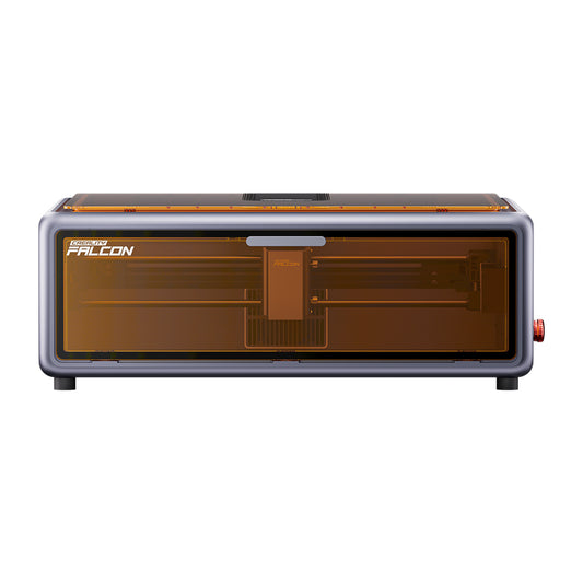 A front view of the compact Creality Falcon Falcon A1 10W Enclosed Diode Laser Engraver shows a modern desktop unit with a transparent amber cover, designed to fit any space and ideal for precise laser engraving or cutting tasks.