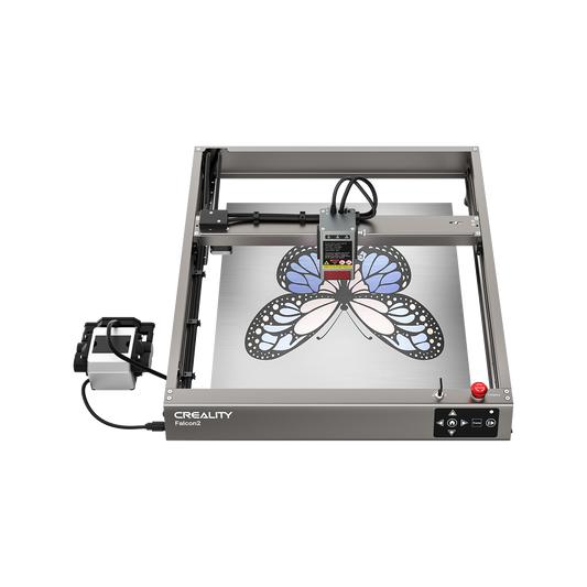 A top view of the Creality Falcon Falcon2 22W Diode Laser Engraver etching a blue and black butterfly design onto metal, highlighting its powerful cutting performance and vivid color engraving abilities. 1600