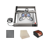 The Creality Falcon Falcon2 22W Laser Engraver and Cutter Ultimate Engraving Package displays a butterfly design on its honeycomb workbench, with accessories like wooden sheets and a sleek black-and-copper enclosure.