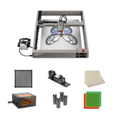 The Creality Falcon Falcon2 22W Diode Laser Engraver offers broad compatibility and comes with a rotary tool, air filter, wood sheets, lens covers, cylindrical parts, and square colored acrylic sheets for versatile engraving projects.