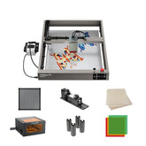 The Creality Falcon Falcon2 40W Diode Laser Engraver with an anodized aluminum alloy structure etches a colorful butterfly onto a flat surface, shown with accessories like extra lenses, wood sheets, roller attachment, air filter, rotary tool, and acrylic sheets.
