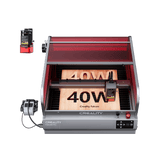 The Creality Falcon Falcon2 Pro 40W Enclosed Diode Laser Engraver, shown with a visual positioning camera, engraves a wooden "40W" board inside its red-tinted protective enclosure; includes a free test kit.