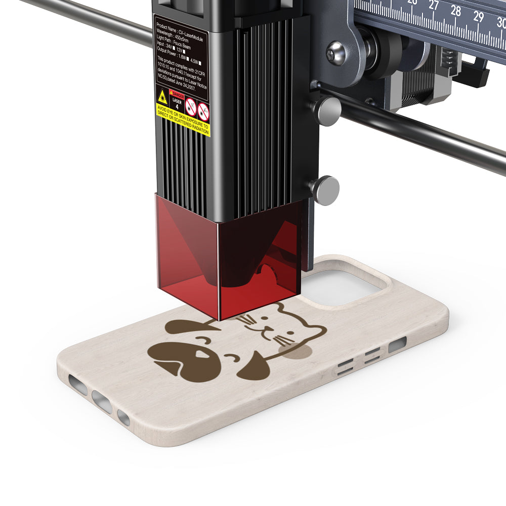 The CrealityFalcon 10W CR-Laser Falcon Engraver Upgrade Package etches a cartoon cat and dog design onto a wooden phone case.