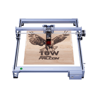 The compact Creality Falcon CR 5W Diode Laser Engraver etches a detailed eagle with outstretched wings and the text 