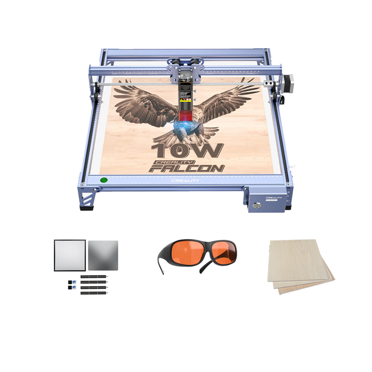 The image depicts the Creality Falcon 10W Laser Engraver and Cutter Bundle Basic Kit in action, intricately engraving an eagle design onto plywood sheets. The text "10W" is clearly visible on the wooden piece. The set comes with orange safety glasses, several rectangular sheets, and small rectangular components as accessories.