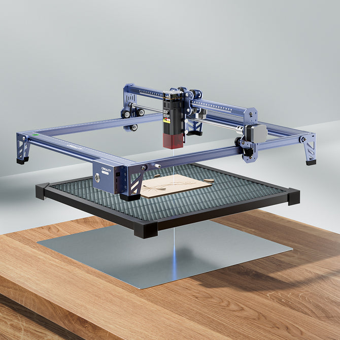 The 10W CR-Laser Falcon Engraver Upgrade Package by CrealityFalcon is engraving wood on a raised grid platform atop a wooden table, set against a minimalist, light background.