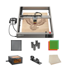 The Creality Falcon Falcon2 12W Laser Engraver and Cutter etches an eagle on a wooden board, surrounded by safety glasses, a filter, an ultra-fast rotary attachment, wooden sheets, and a protective cover.