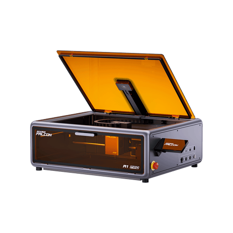 The Creality Falcon Falcon A1 Pro 20W Dual-laser Engraver is a desktop machine with an open orange-tinted lid, revealing the interior work area and laser mechanism, and is labeled "Falcon A1 Pro" on the front.