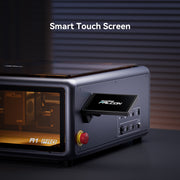 The Creality Falcon A1 Pro 20W Dual-laser Engraver, shown with a metallic finish and smart touch screen display, is set against a striped background with soft lighting. Includes a free test kit.