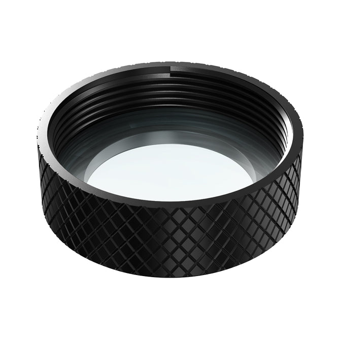 Close-up of a CR-Laser Falcon Replace Protective Lens by Creality Falcon, featuring a black metal lens cap with diamond-patterned grip. The circular design has a clear glass center, internal threading for attachment, and is compatible with CR-Laser systems. The angle highlights depth and intricacies.