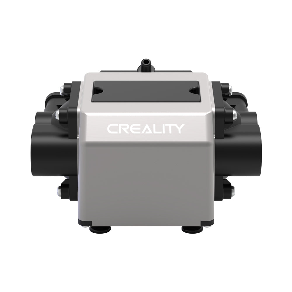 Front view of a metallic Creality Falcon Air Assist for the CR-Laser Falcon 7.5W and 10W Engraver, featuring "Creality" branding. The device is known for its low working noise and has a rectangular shape with cylindrical elements on its sides, supported by four small feet at the base. The background is plain white.