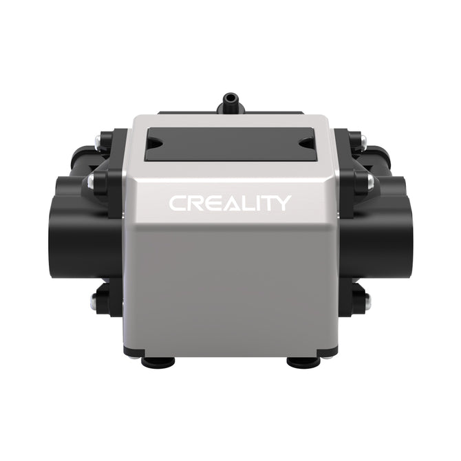 Front view of a metallic Creality Falcon Air Assist for the CR-Laser Falcon 7.5W and 10W Engraver, featuring "Creality" branding. The device is known for its low working noise and has a rectangular shape with cylindrical elements on its sides, supported by four small feet at the base. The background is plain white.