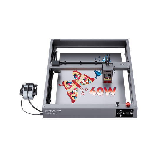 A gray Creality Falcon2 40W Laser Engraver and Cutter by Creality Falcon, featuring an anodized aluminum frame, engraves a colorful butterfly and "40W" text on a flat surface with the control panel and power supply on the left.