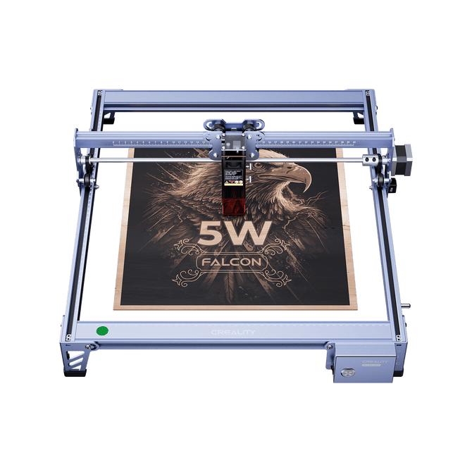 The Creality Falcon CR 5W Diode Laser Engraver etches an eagle image with "5W FALCON" onto wood. Its metallic frame ensures ultra-fine engraving precision, delivering impressive detail.