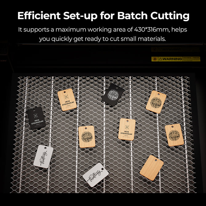 Wood and metal tags with different logos are arranged on the 460*346mm Honeycomb Workbench for Creality Falcon A1 by CrealityFalcon. The text above highlights efficient set-up and describes the spacious working area.