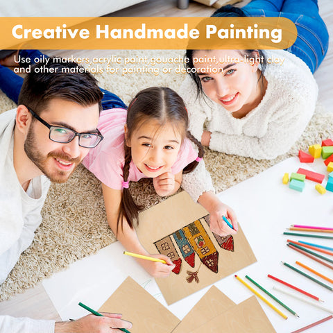 A cheerful family of three lies on Creality Falcon's eco-friendly Basswood Plywood Sheets, with colored pencils scattered nearby. The father wears glasses, while the mother and daughter have long hair. At the top is text reading "Creative Handmade Painting.