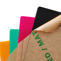 Ten 12x12x1/8'' Intelligent Recognition Frosted Colorful Acrylic Sheets by Creality Falcon, showing glossy surfaces where the protective brown paper is partially removed.