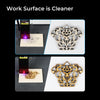 Using the Air Assist for CR-Laser Falcon 7.5W and 10W Engraver by Creality Falcon, a floral design is intricately etched onto a square piece of wood. The top image captures the laser in action, while the bottom image reveals the completed delicate design. The accompanying text highlights that with this product, "Work Surface is Cleaner.
