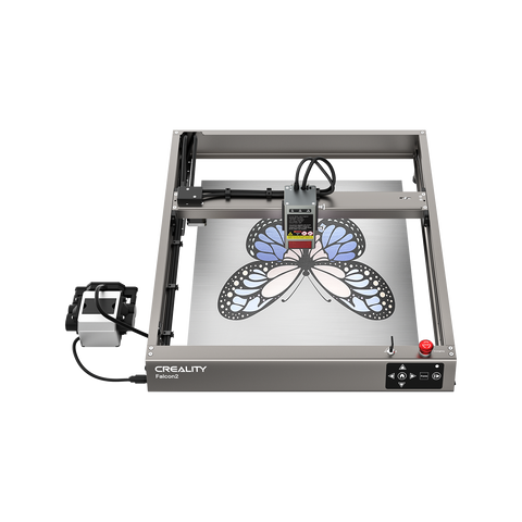 A top view of the Creality Falcon Falcon2 22W Diode Laser Engraver etching a blue and black butterfly design onto metal, highlighting its powerful cutting performance and vivid color engraving abilities.