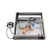 The Creality Falcon Falcon2 40W Laser Engraver and Cutter is etching colorful butterfly designs onto a surface, showcasing its versatility as a desktop machine for creative projects. Free Test Kit included with purchase.