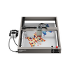 A Creality Falcon Falcon2 40W Diode Laser Engraver with an anodized aluminum alloy frame engraves colorful butterfly designs on a flat surface, its head positioned above the artwork.