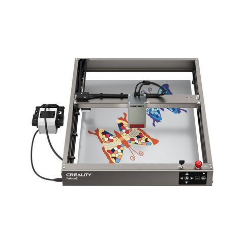 A Creality Falcon Falcon2 40W Diode Laser Engraver with an anodized aluminum alloy frame engraves colorful butterfly designs on a flat surface, its head positioned above the artwork.