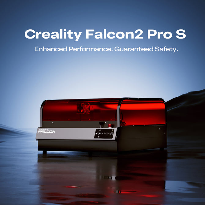 A Creality Falcon2 Pro S 40W Enclosed Diode Laser Engraver, featuring a black and red design, is displayed on a reflective surface with the message "Enhanced Performance. Guaranteed Safety." above. Brand: Creality Falcon.