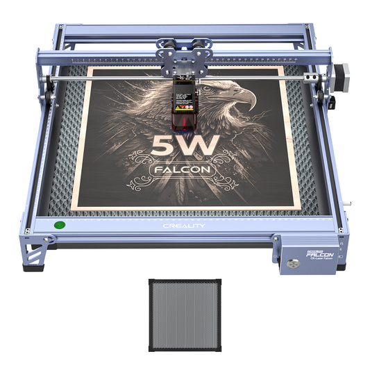 The 5W CR-Laser Falcon Engraver and Cutter by Creality Falcon demonstrates its precise engraving by etching a detailed eagle and “5W Falcon” on wood, using a removable honeycomb panel for versatile materials.