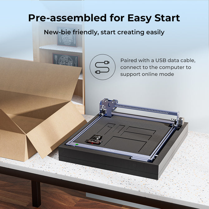 A partially unpacked CrealityFalcon 5W CR-Laser Falcon Engraver Upgrade Package sits on a table by an open box. It’s pre-assembled, beginner-friendly, and includes a USB data cable for simple computer connection.