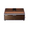 The Creality Falcon A1 10W Enclosed Diode Laser Engraver features Auto Materials Recognition, a transparent amber lid, and a control button on the right. Its compact design fits any space and "Falcon" is labeled on the front panel.