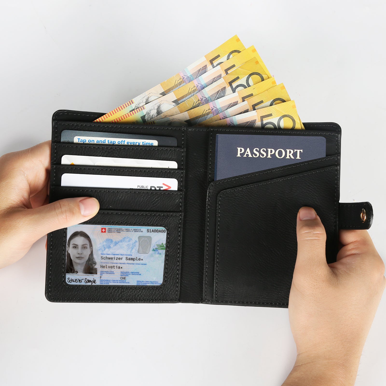 Hands holding a Creality Falcon Custom Leather Passport Holder with laser engraving, showcasing a personalized passport, multiple credit cards, several banknotes, and an ID card with a photo.
