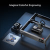 The Creality Falcon Falcon2 22W Diode Laser Engraver etches a vibrant butterfly onto a flat metal sheet, with "Magical Colorful Engraving" displayed above.