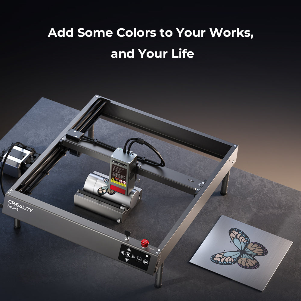 A Creality Falcon2 40W Laser Engraver and Cutter for sale + Free Test Kit sits on a table beside a metal plate engraved with a colorful butterfly. Above, text reads: "Add Some Colors to Your Works, and Your Life." LightBurn compatible.