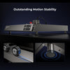 The Creality Falcon Falcon2 40W Diode Laser Engraver, built with an anodized aluminum alloy frame, is displayed on a table under the text "Outstanding Motion Stability," with insets showing its roller wheels and rubberized foot for stability.