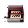 The Creality Falcon Falcon2 Pro 22W Enclosed Laser Engraver and Cutter, featuring a red-tinted Class 1 Safety cover, precisely etches "22W" and "Creality Falcon" on wood; power supply and control panel are visible.