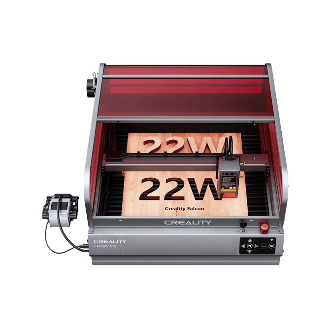 The Creality Falcon Falcon2 Pro 22W Enclosed Laser Engraver and Cutter, featuring a red-tinted Class 1 Safety cover, precisely etches "22W" and "Creality Falcon" on wood; power supply and control panel are visible.